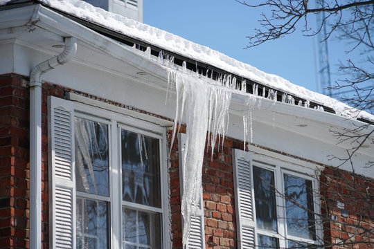 16 Tips to winterize your home OKC, frozen gutters.